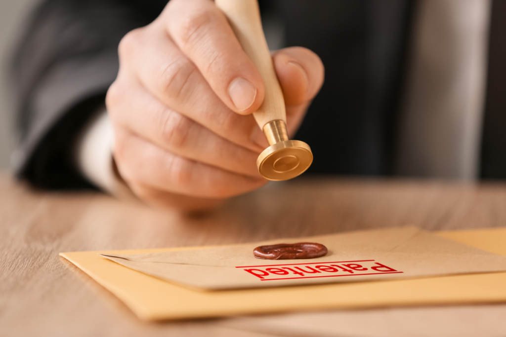 A man writing a letter with a stamp on it and a stamp on the envelope.